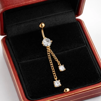 Ocelový zlacený piercing do pupíku s visacími zirkony